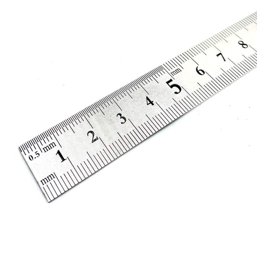 Maßstab aus Metall mit mm Einteilung auf beiden Seiten.